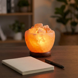 Lampe de sel de l'Himalaya allumée sur un bureau avec un carnet