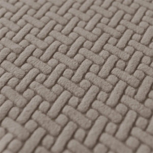 Gros plan sur la texture jacquard entrelacée de la housse de fauteuil