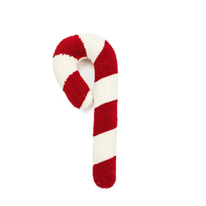 Un coussin Noël en peluche festif en forme de bonbon rond et de canne gourmande avec motifs tourbillonnants, posé sur fond neutre et évoquant les douceurs traditionnelles des fêtes.