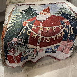 Un plaid de Noël tissé Jacquard étendu sur un lit, avec des motifs festifs hivernaux et des franges décoratives, créant une ambiance chaleureuse et accueillante pour les fêtes.