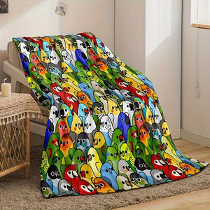 Un plaid enfant à motifs oiseaux colorés recouvrant un fauteuil, avec de nombreux petits oiseaux illustrés aux expressions variées dans un intérieur chaleureux.