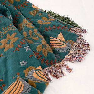 Détail des franges à pompons colorés du plaid bohème