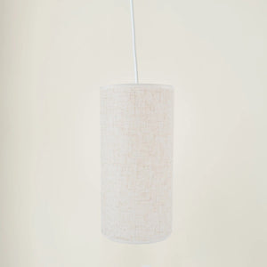 Abat-jour tambour en lin suspendu sur fond neutre
