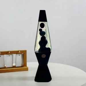 Lampe à lave noire éteinte posée sur un bureau