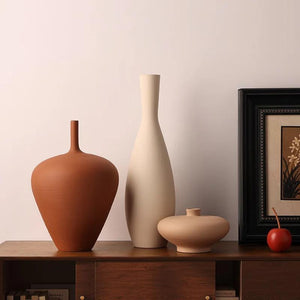 Trois vases céramique mat nordique terracotta et beige sur buffet en bois