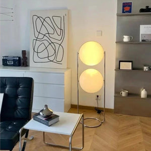 Lampadaire deux boules dans un salon gris avec bibliothèque