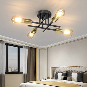 Lustre Sputnik noir et or 4 bras dans une chambre
