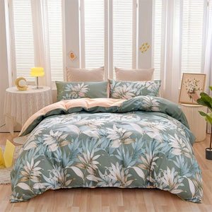 Parure de lit feuilles tropicales verte et pêche avec housse de couette et deux taies sur un lit