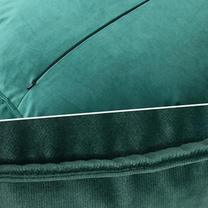 Gros plan sur la texture du velours vert émeraude du coussin rond