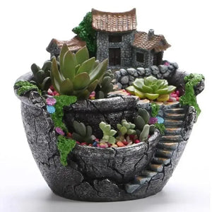 Pot de fleurs village miniature gris rempli de plantes succulentes