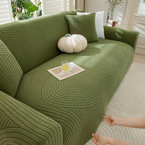 Housse velours vert foncé ajustée sur canapé
