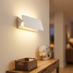 Applique murale LED blanche installée dans une entrée avec console en bois