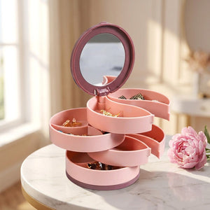 Boîte à bijoux rotative rose ouverte sur marbre avec pivoine
