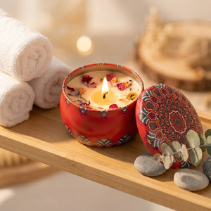 Bougie parfumée allumée sur une étagère de salle de bain avec serviettes roulées et eucalyptus