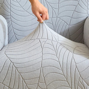 Détail du tissu jacquard feuilles extensible de la housse de fauteuil