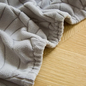 Détail de la couture et du tissu épais de la housse de fauteuil