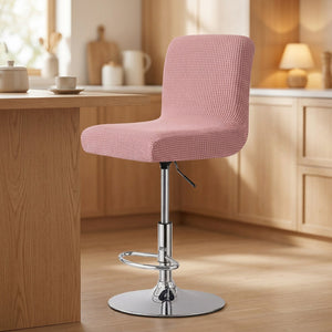Housse de chaise de bar en jacquard texturé coloris rose sur un tabouret