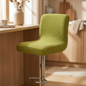 Housse de chaise de bar en jacquard texturé coloris vert sur un tabouret