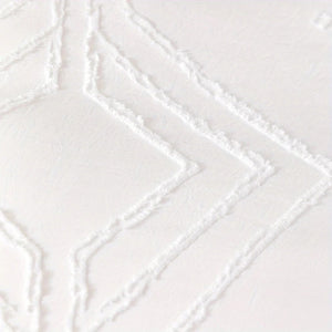 Détail du motif grille capitonnée de la housse de couette bohème