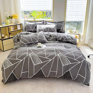 Housse de couette motif géométrique gris et blanc vue complète sur un lit