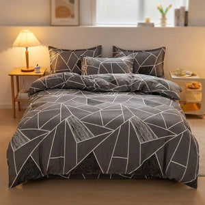 Housse de couette grise à motif géométrique dans une chambre moderne avec table de chevet