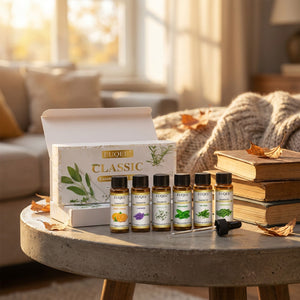 Coffret d'huiles essentielles sur une table d'appoint en béton avec des livres et une lumière dorée