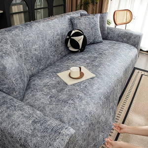 Housse de canapé jacquard grise installée sur un canapé
