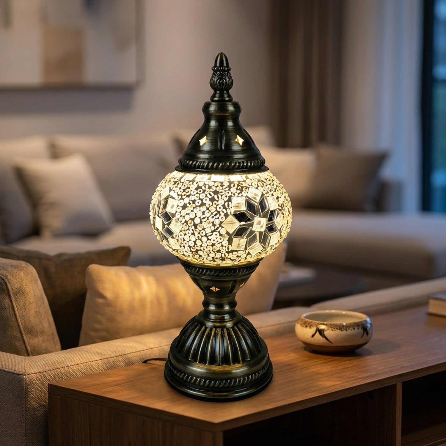 Lampe de table mosaïque allumée sur un meuble console dans un salon moderne le soir