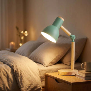 Lampe de bureau verte allumée sur une table de chevet dans une chambre chaleureuse
