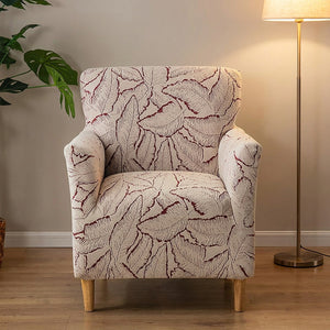 Housse de fauteuil bordeaux à motif de feuilles jacquard sur un fauteuil dans un salon élégant
