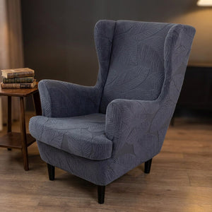 Fauteuil bergère gris foncé à motif jacquard dans un coin bureau avec livres