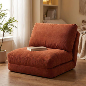Fauteuil de sol terracotta avec un livre dans un coin lecture près d'une fenêtre