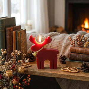 Bougie cerf rouge sur étagère en bois avec fleurs séchées ambiance cosy