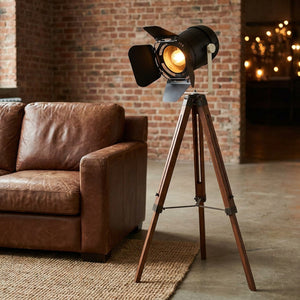 Lampadaire projecteur vintage près d'un canapé en cuir dans un loft industriel