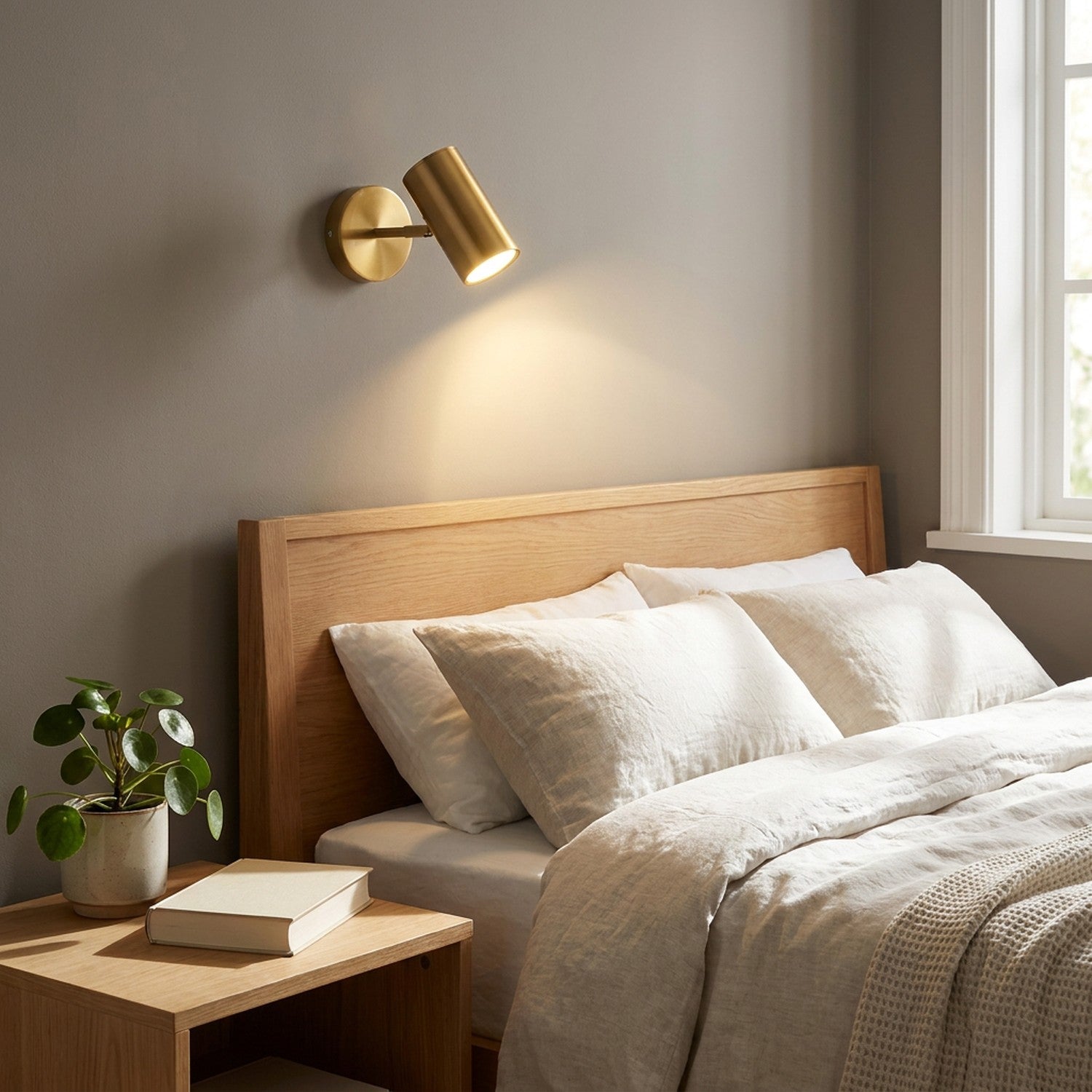 Applique murale LED dorée dans une chambre au-dessus de la tête de lit