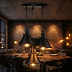 Lustre industriel 3 suspensions noir au-dessus d'une grande table à manger dans un appartement loft briques apparentes