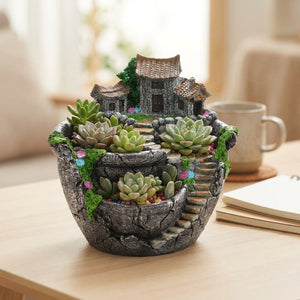 Pot de fleurs village miniature gris en résine garni de plantes succulentes