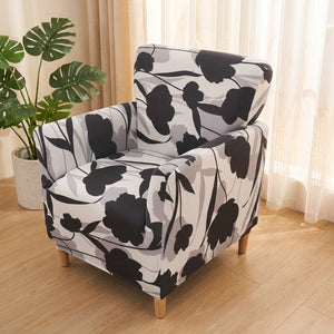 Fauteuil club habillé d'une housse extensible imprimée dans un salon lumineux et chaleureux
