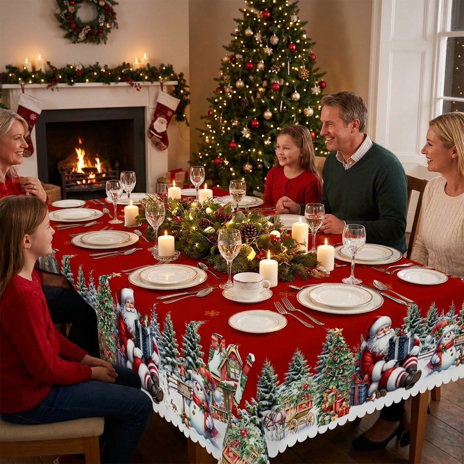 Table de réveillon de Noël dressée avec nappe rouge imperméable motif Père Noël décor festif