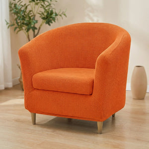 Housse de fauteuil club en jacquard orange sur un fauteuil arrondi
