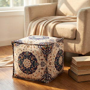Pouf marocain utilisé comme repose-pieds devant un fauteuil de lecture cosy