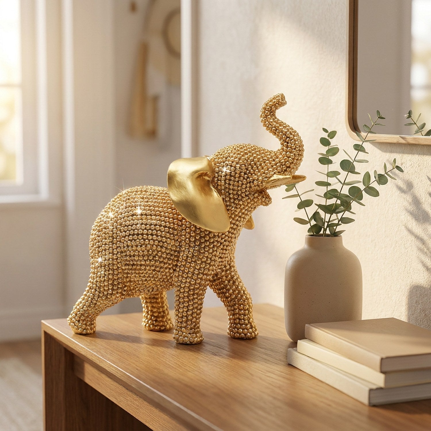Statue éléphant doré posée sur une console en bois dans une entrée lumineuse