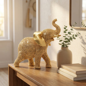 Statue éléphant doré posée sur une console en bois dans une entrée lumineuse