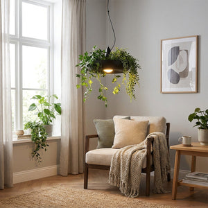 Suspension pot de fleurs LED noire dans un coin salon avec plantes retombantes