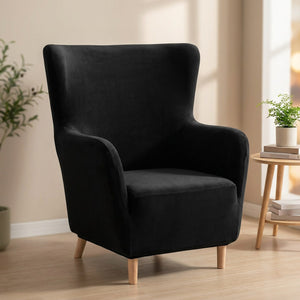 Housse de fauteuil à oreilles en velours noir sur un fauteuil une place
