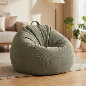 Housse de pouf poire en velours côtelé vert olive dans un salon