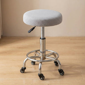Housse de chaise ronde coloris gris sur tabouret de bar