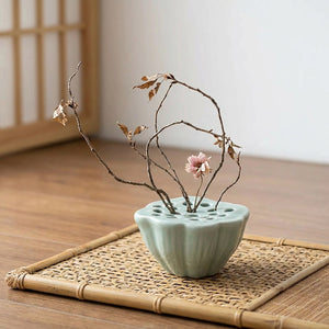 Vase Ikebana lotus en céramique céladon avec arrangement de fleurs séchées sur natte en bambou