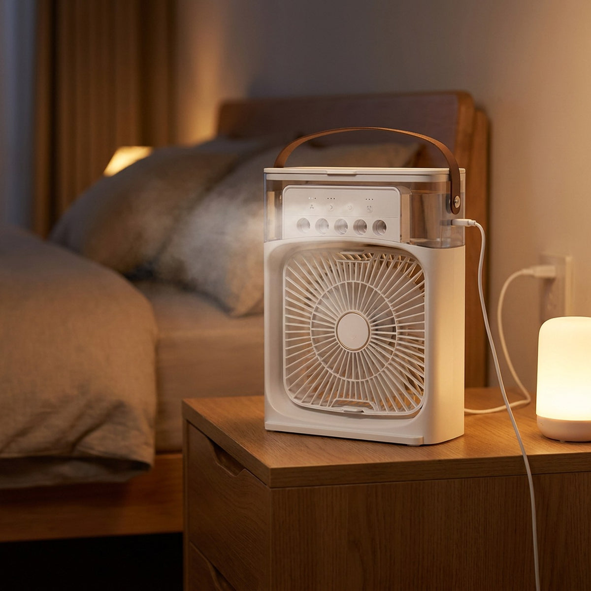 Ventilateur climatiseur blanc posé sur une table de chevet dans une chambre chaleureuse