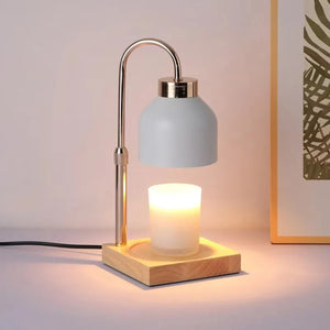 Lampe chauffe-bougie blanche vue de face sur socle en bois